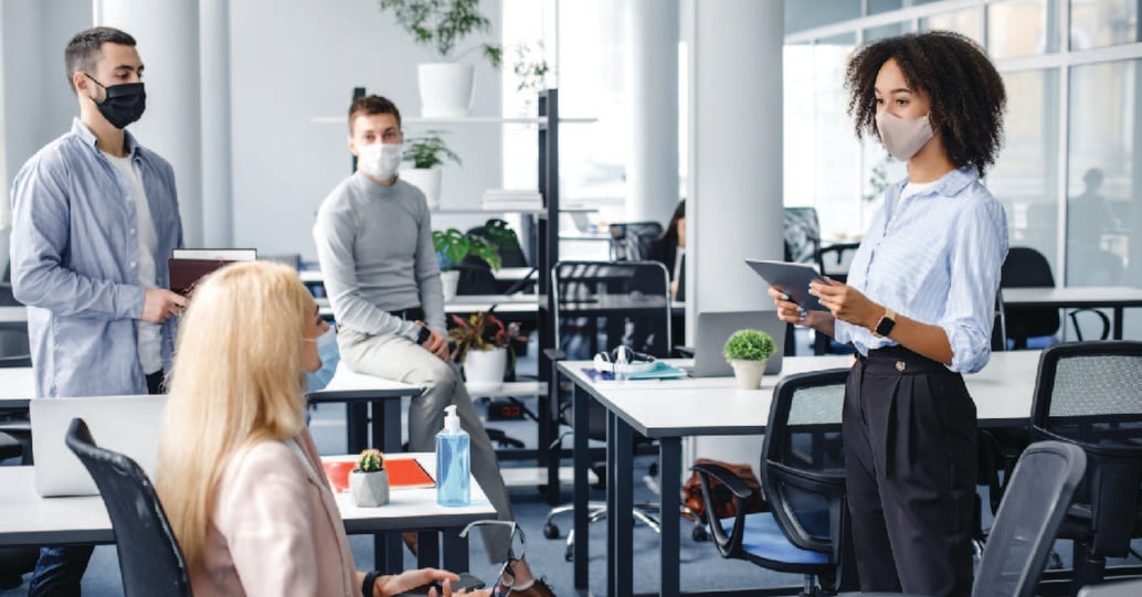 Group of masked employees in the office