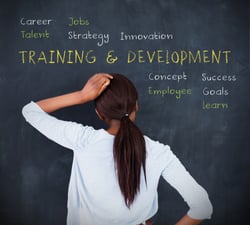 Attractive woman looking at a chalkboard with business terms written on it