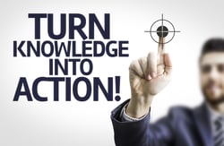Business man pointing to transparent board with text Turn Knowledge Into Action!-1