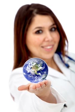 Female doctor with a globe in her hand isolated over a white background