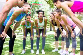 Group of marathon runners discussing before a race in the park