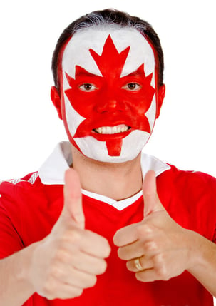 Happy Canadian man with the flag painted on his face and thumbs up- isolated.jpeg
