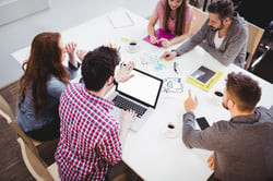 High angle view of young partners discussing in meeting room