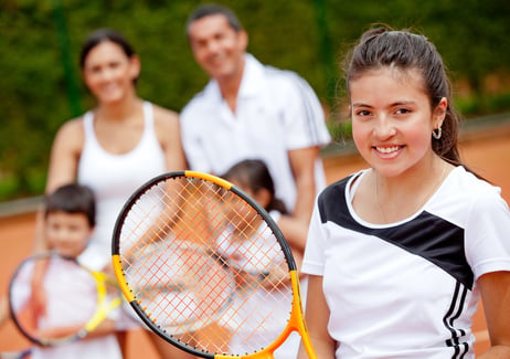 Teenager Playing Tennis with Family