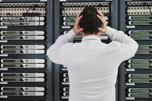business man in network server room have problems and looking for  disaster solution.jpeg