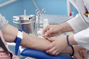 close up of blood extraction in lab
