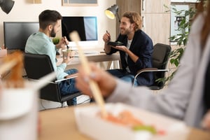 Employees eating sushi together