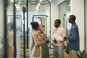 Group of 4 in a conversation at work