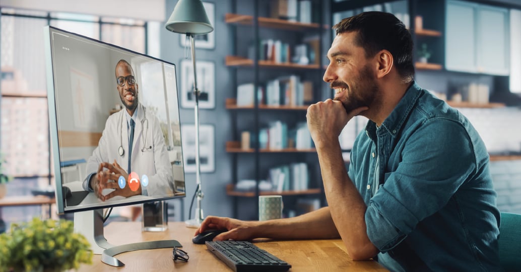 Man at home on telemedicine call with doctor