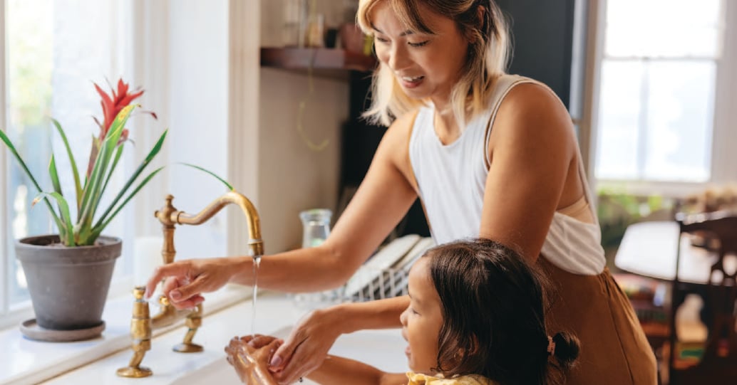 Mother and daughter washing hands