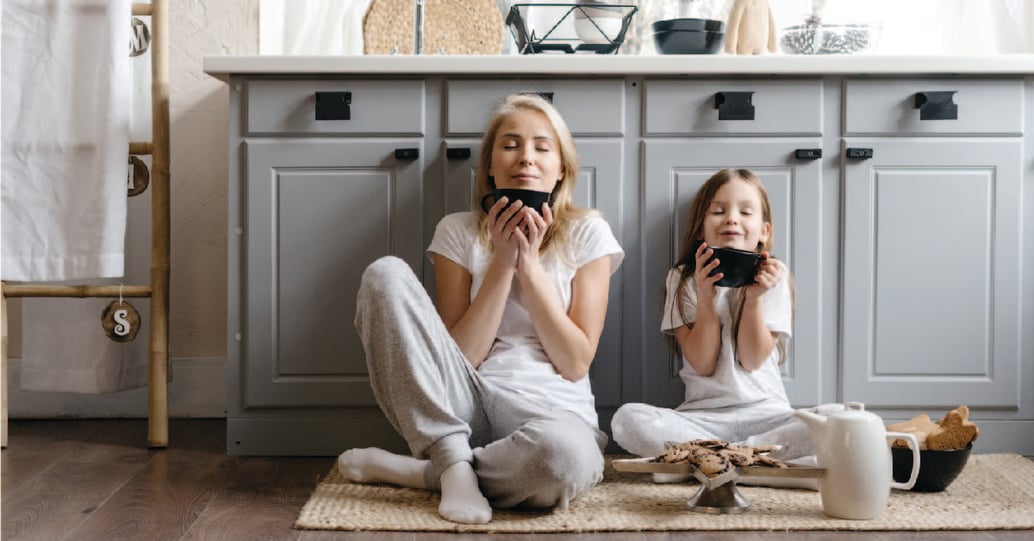 Relaxed mother and daughter in kitchen