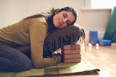 Attractive mixed race woman doing restorative yoga-1