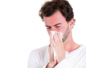 Closeup portrait of sick, ill young man, student, worker with allergy, germs cold, blowing his nose with kleenex, looking miserable, unwell, very sick isolated on white background. Flu season, vaccine-1