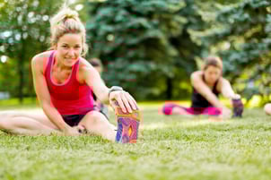 Portait of a blond girl getting streching her legs before running outdoors.jpeg