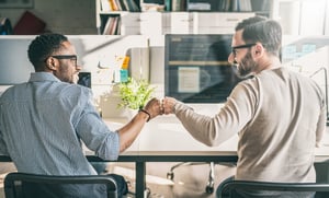 Two Co-Workers Fist Bump