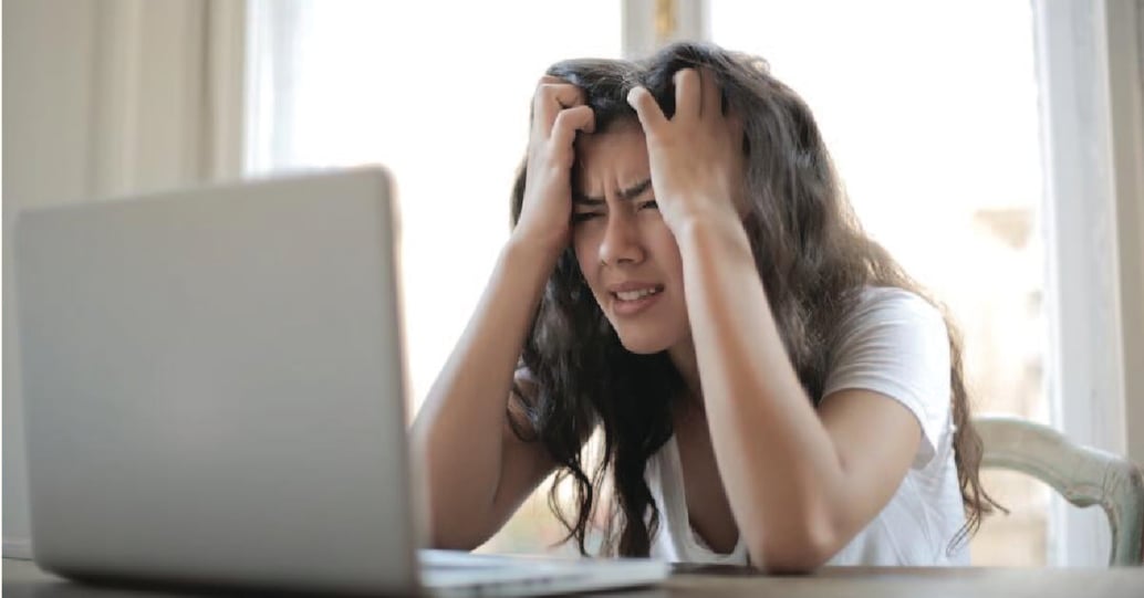 Stressed woman looking at laptop