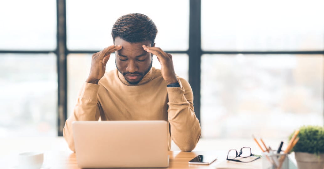 Man working from home facing burnout