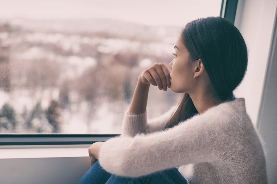 woman looking out window