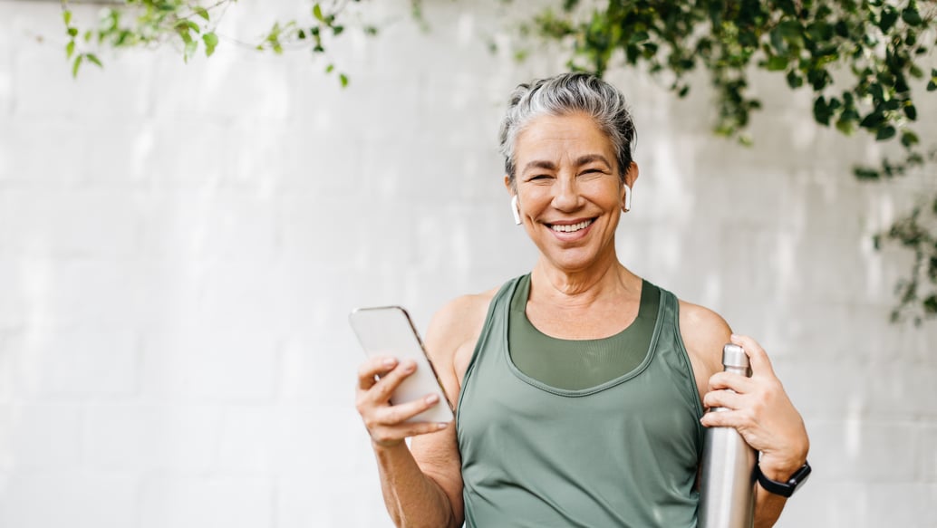 Smiling woman holding water bottle