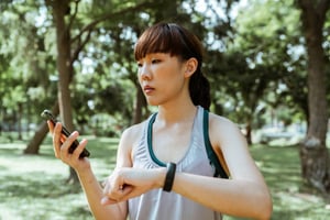 jogger looking at phone and watch