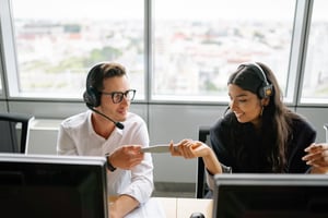 Two People at Desk With Headset On